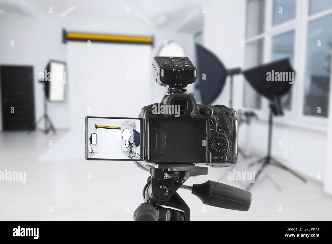 Professional camera on tripod in photo studio Stock Photo - Alamy