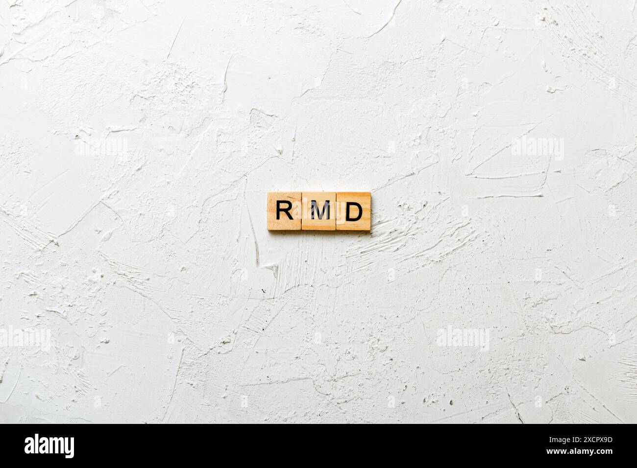 RMD word written on wood block. Required Minimum Distributions text on table, concept. Stock Photo