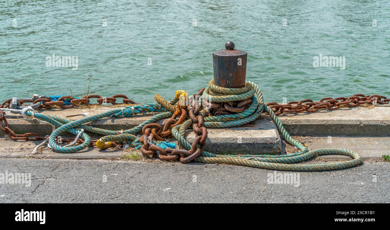 Chain And Rope Waterside bollard with ropes and chains seen in Normandy, France Stock ...