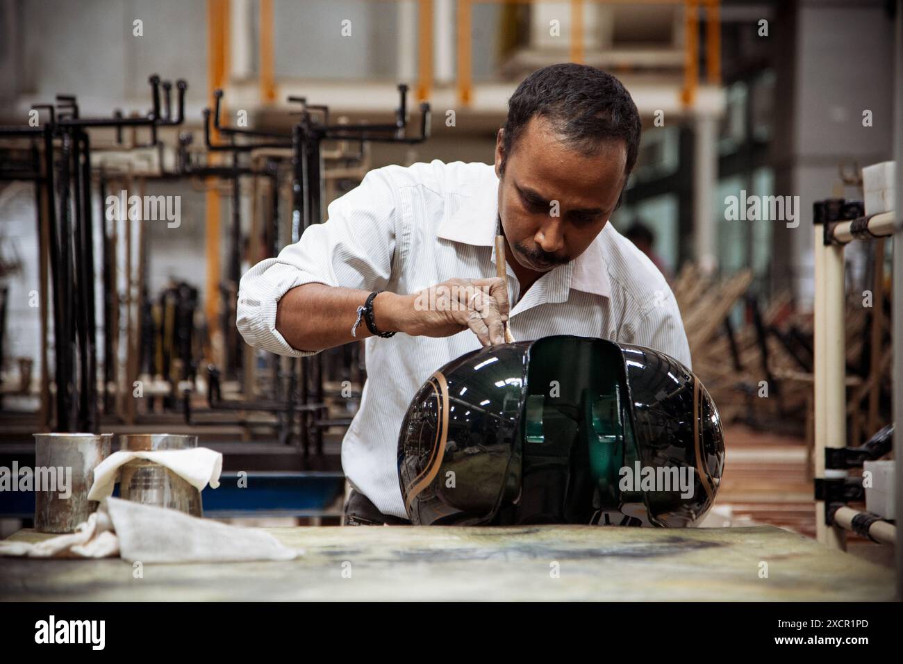 Craftsman at the Royal Enfield factory in Chennai India painting fuel tanks for the motorcycles Stock Photo