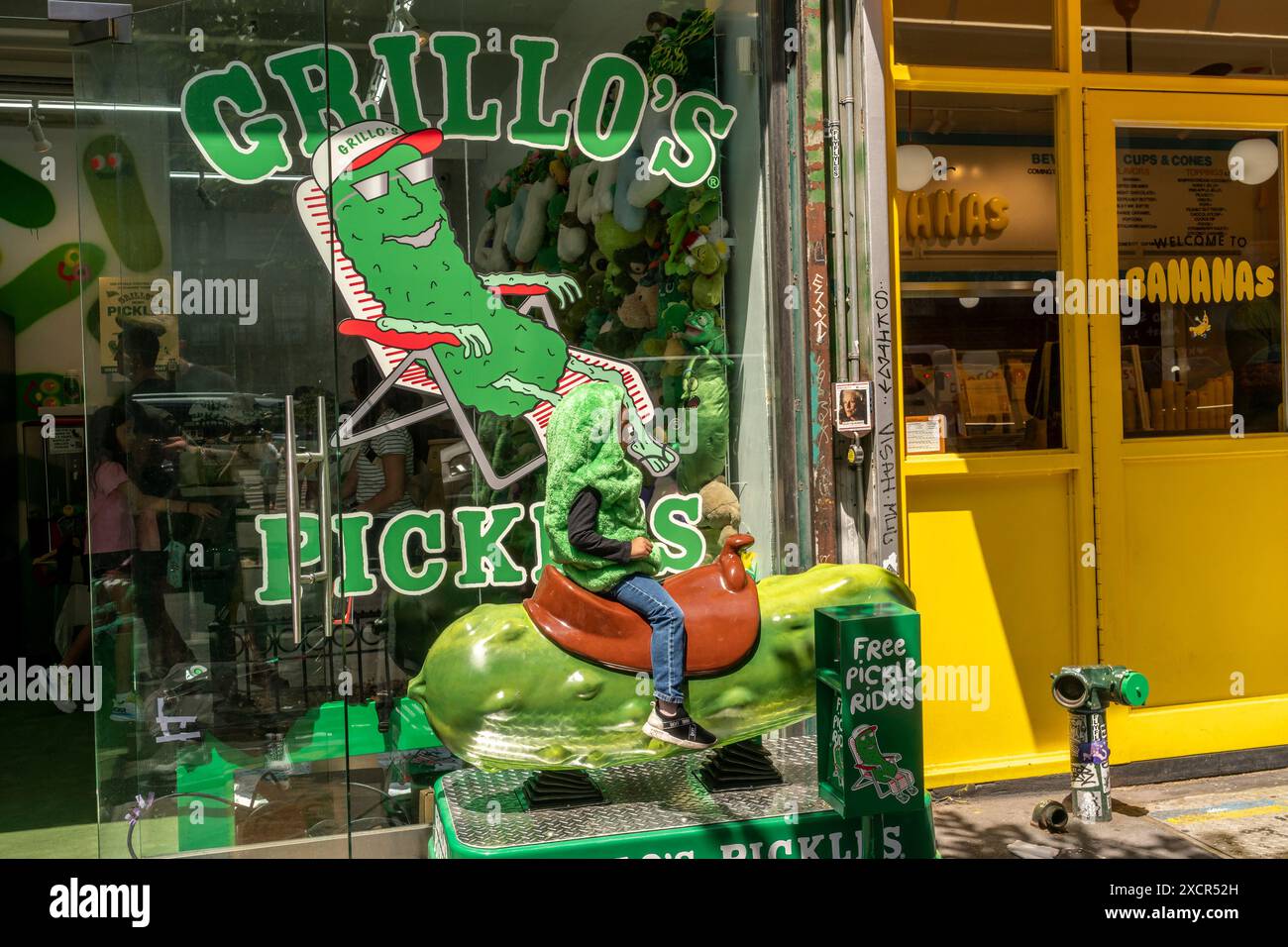 A child dressed as a pickle takes a ride on a pickle at the GrilloÕs