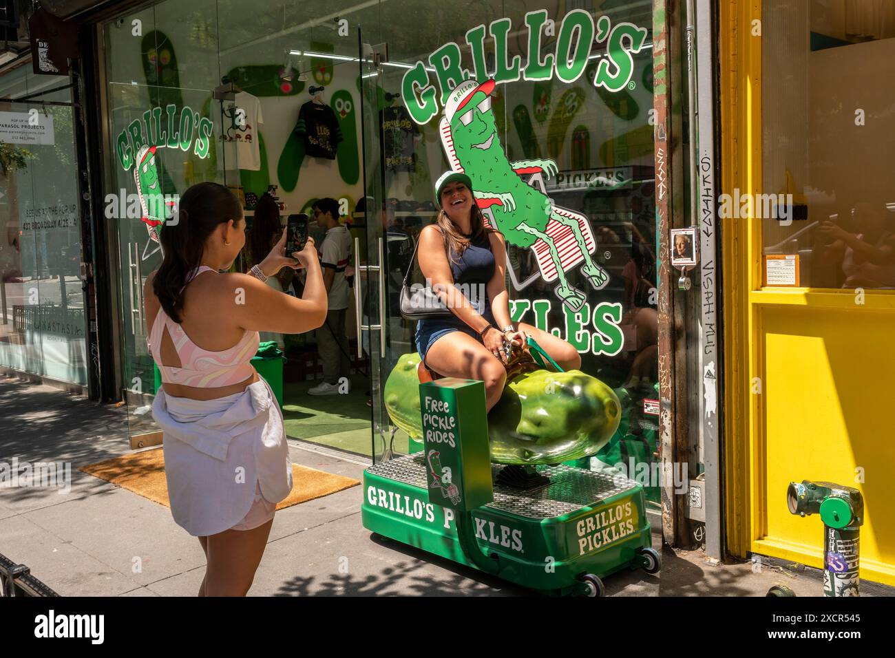 Woman takes a ride on a pickle at the GrilloÕs Pickles brand activation