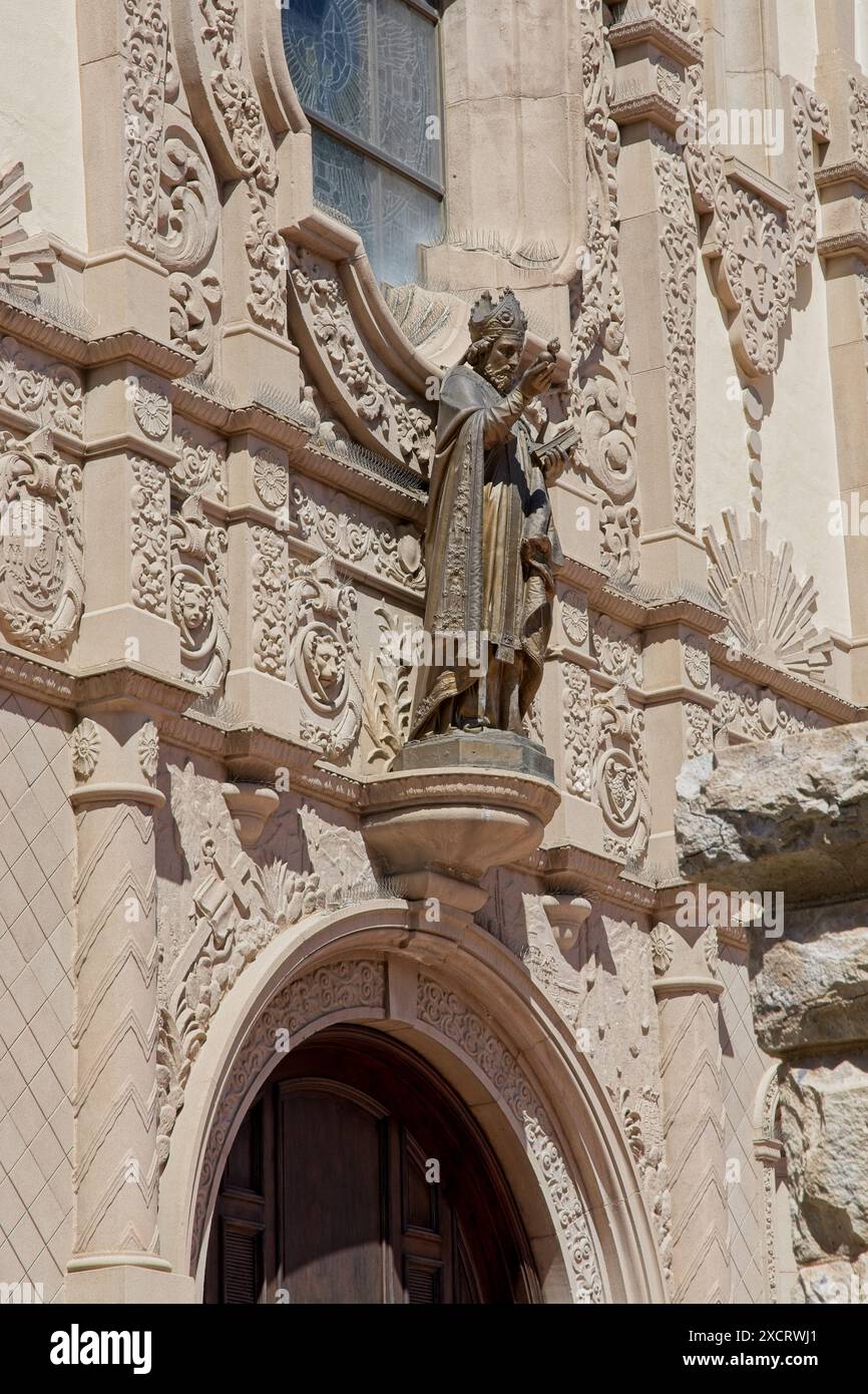 Bronze statue of Saint Augustine mounted to ornate facade at entrance to Saint Augustine Cathedral  in downtown Tucson — Arizona, April 2024 Stock Photo