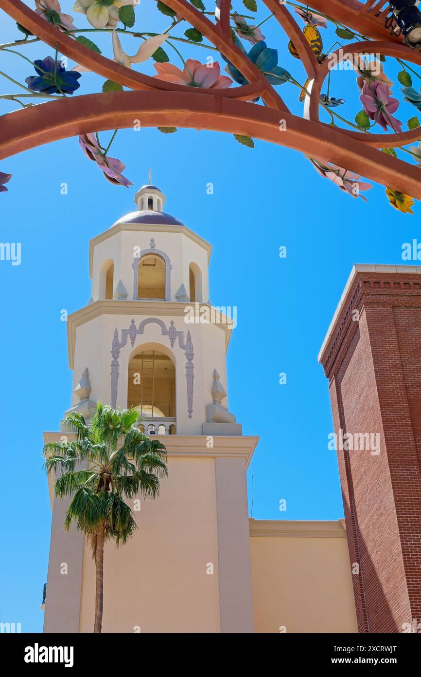 Spanish colonial revival style tower of Saint Augustine Cathedral framed by floral archway — Tucson Arizona, April 2024 Stock Photo