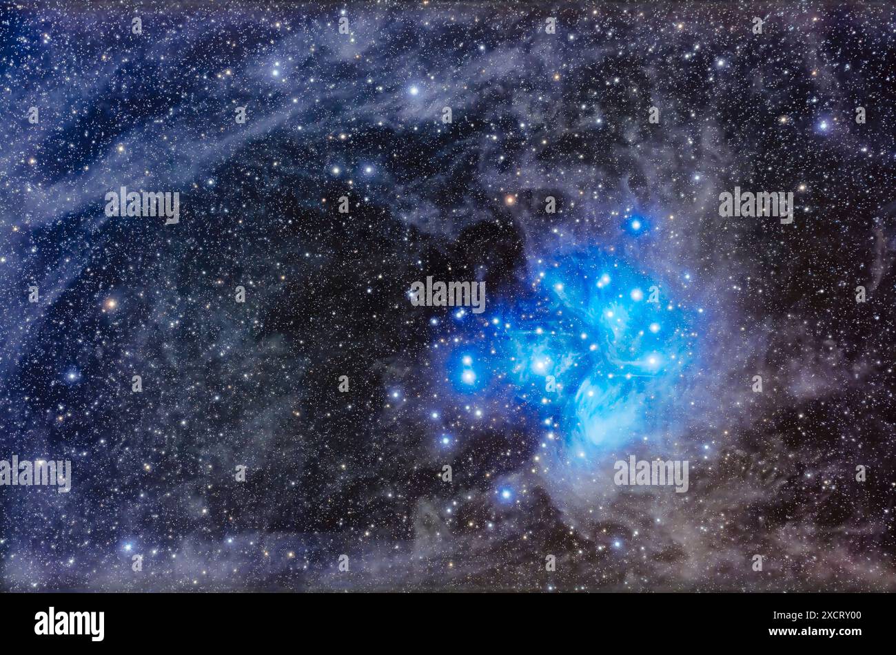 This frames the famous Pleiades or Seven Sisters star cluster (aka Messier or M45) set amid a dusty starfield in Taurus. The blue stars of the Pleiade Stock Photo