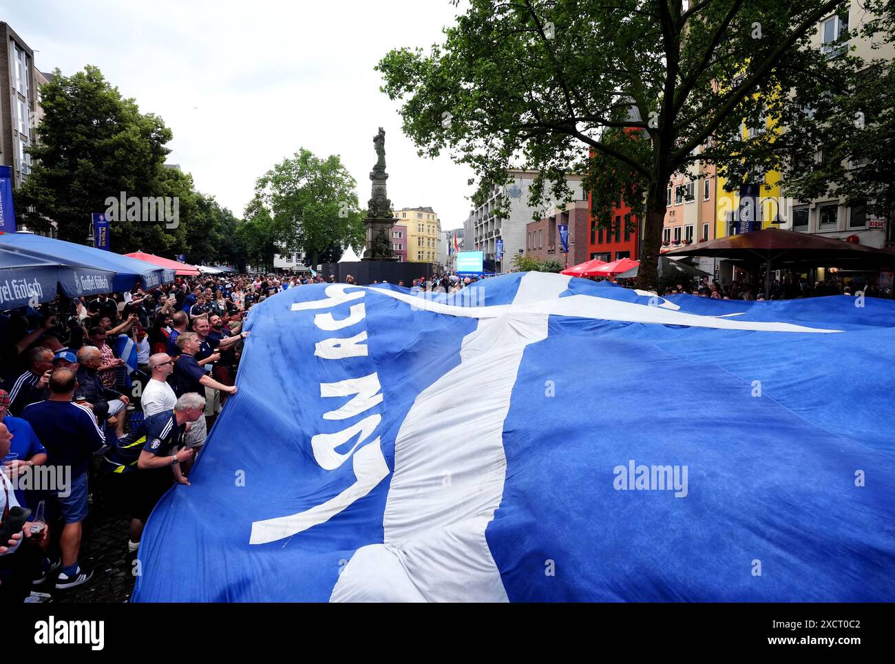 Scotland fans at the Old Market in Cologne, hold up a large banner