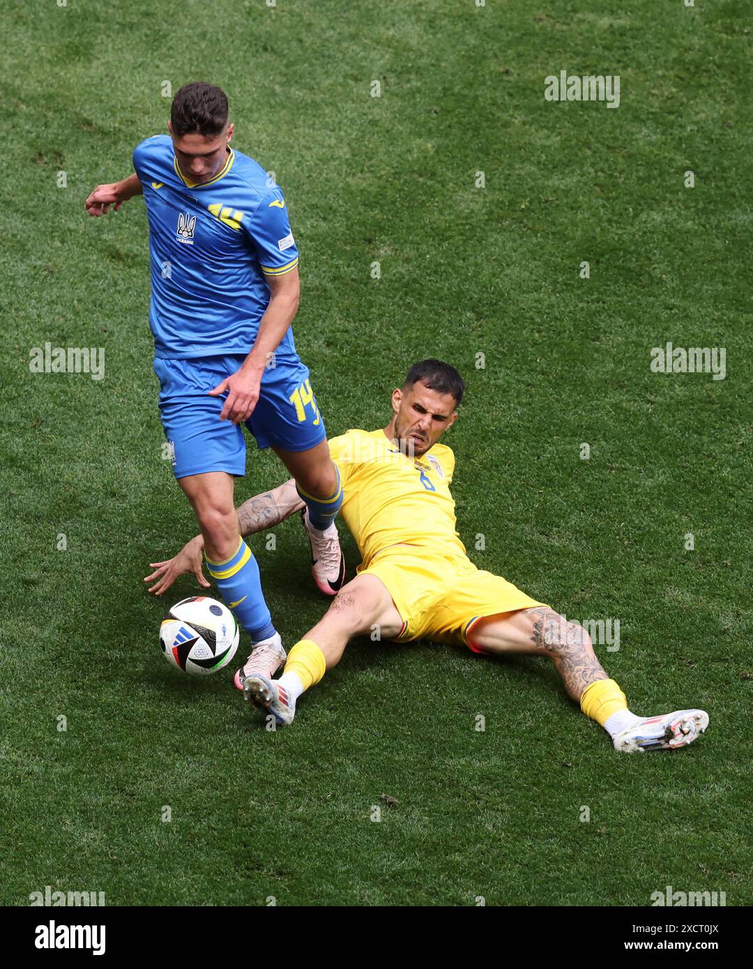 MUNICH, GERMANY - JUNE 17: Georgiy Sudakov of Ukraine vies with Marius Marin of Romania during the UEFA EURO 2024 group stage match between Romania and Ukraine at Munich Football Arena on June 17, 2024 in Munich, Germany. © diebilderwelt / Alamy Stock Stock Photo