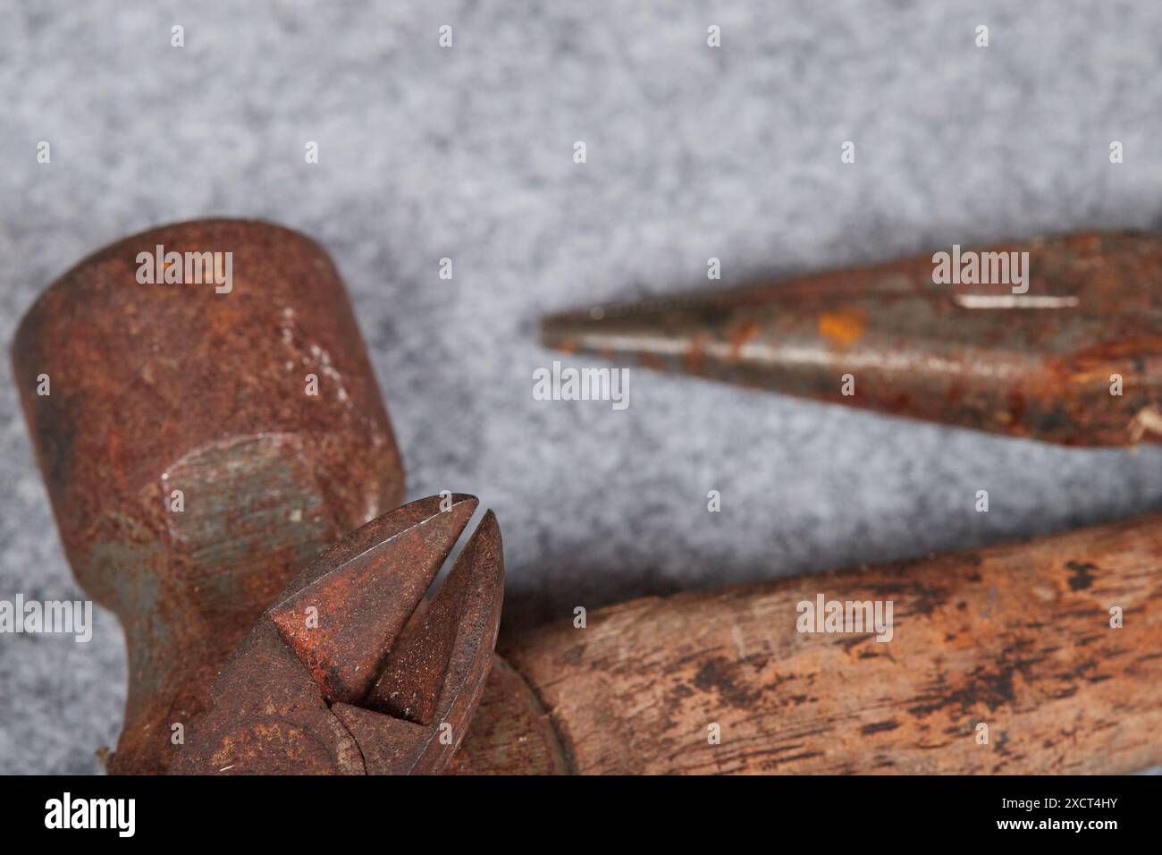 Rusty neglected hand tools, pliers, screwdriver and a hammer! Stock Photo