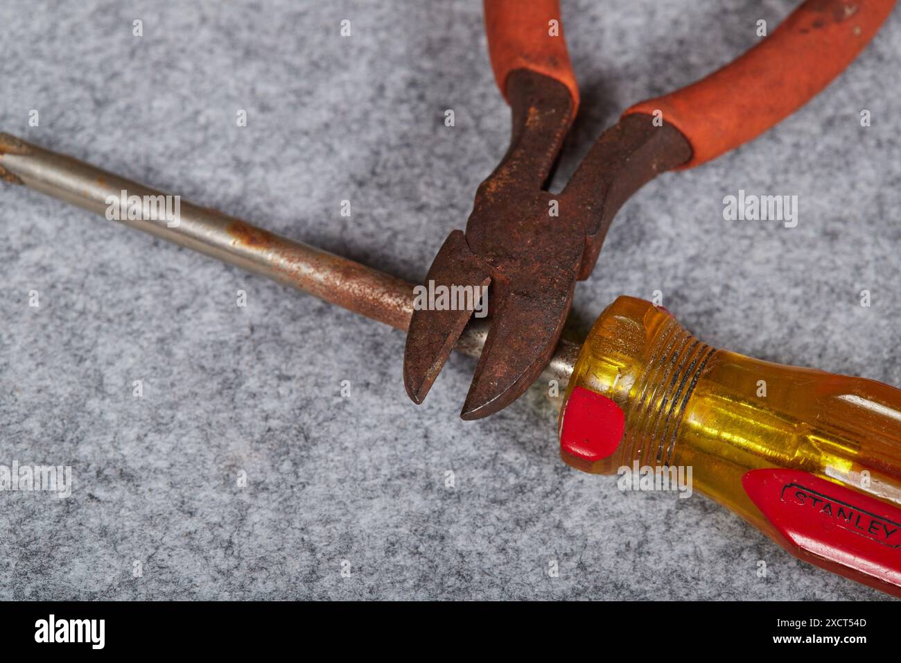 Rusty neglected hand tools, pliers, screwdriver and a hammer! Stock Photo