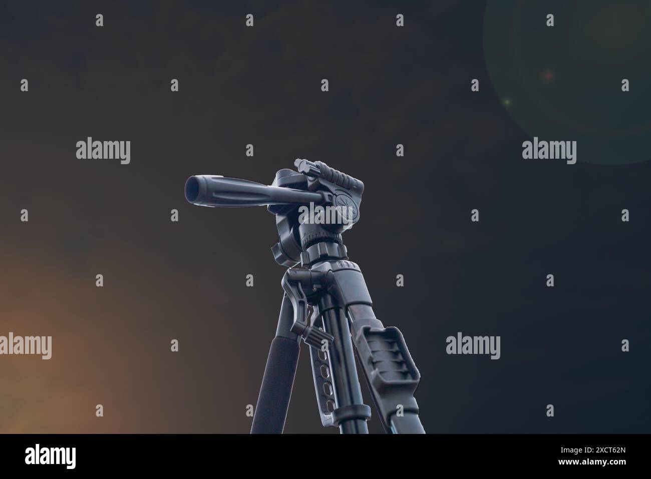 Camera stand accessories with dark sky background and lighting flare ...