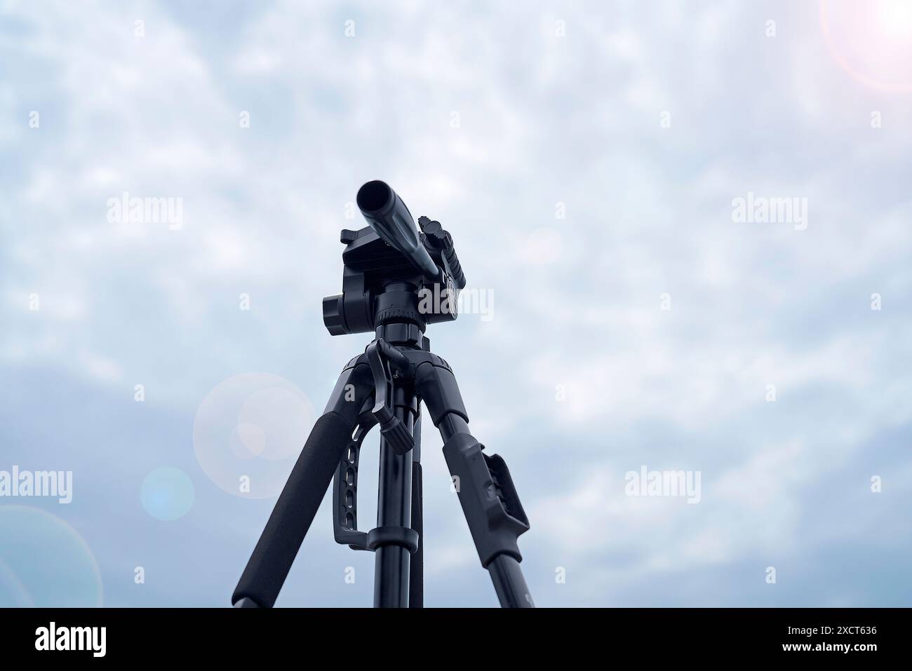 Camera stand accessories with blue sky background and lighting flare ...