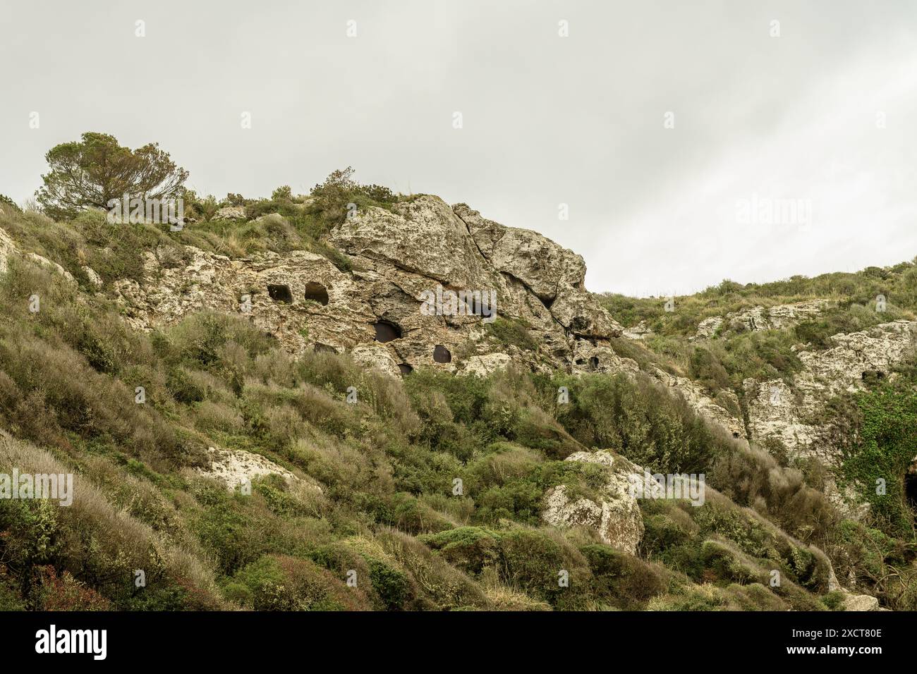 Close-up of the ancient necropolis caves at Cala Coves, Menorca ...