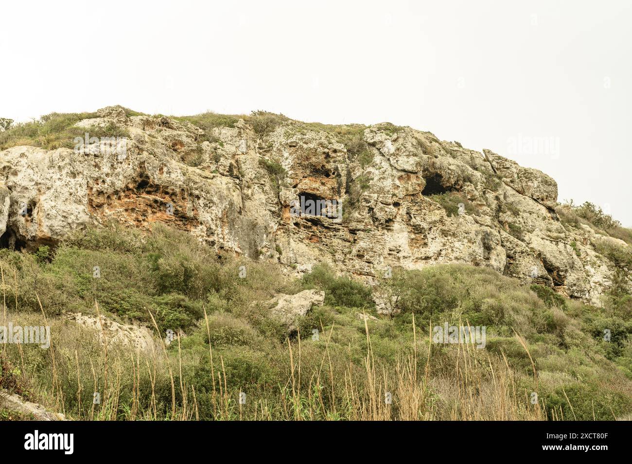 Close-up of the ancient necropolis caves at Cala Coves, Menorca ...
