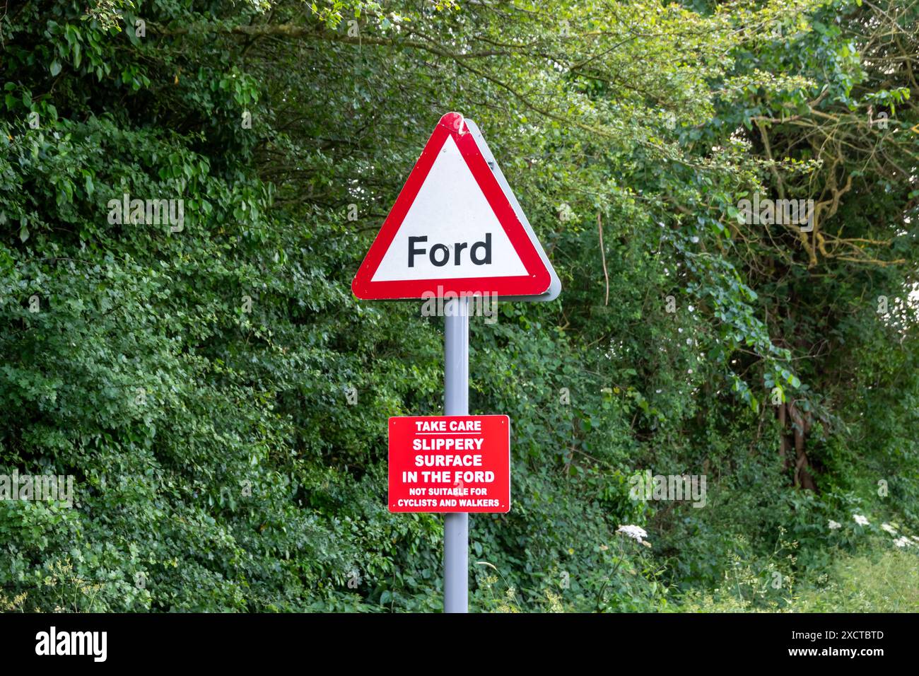 Road warning sign for a river Ford and slippery surface sign in Hinxton Cambridgeshire Stock Photo