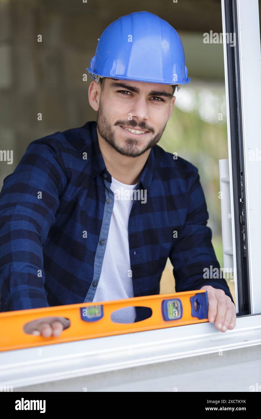Male builder behind brick wall hi-res stock photography and images - Alamy