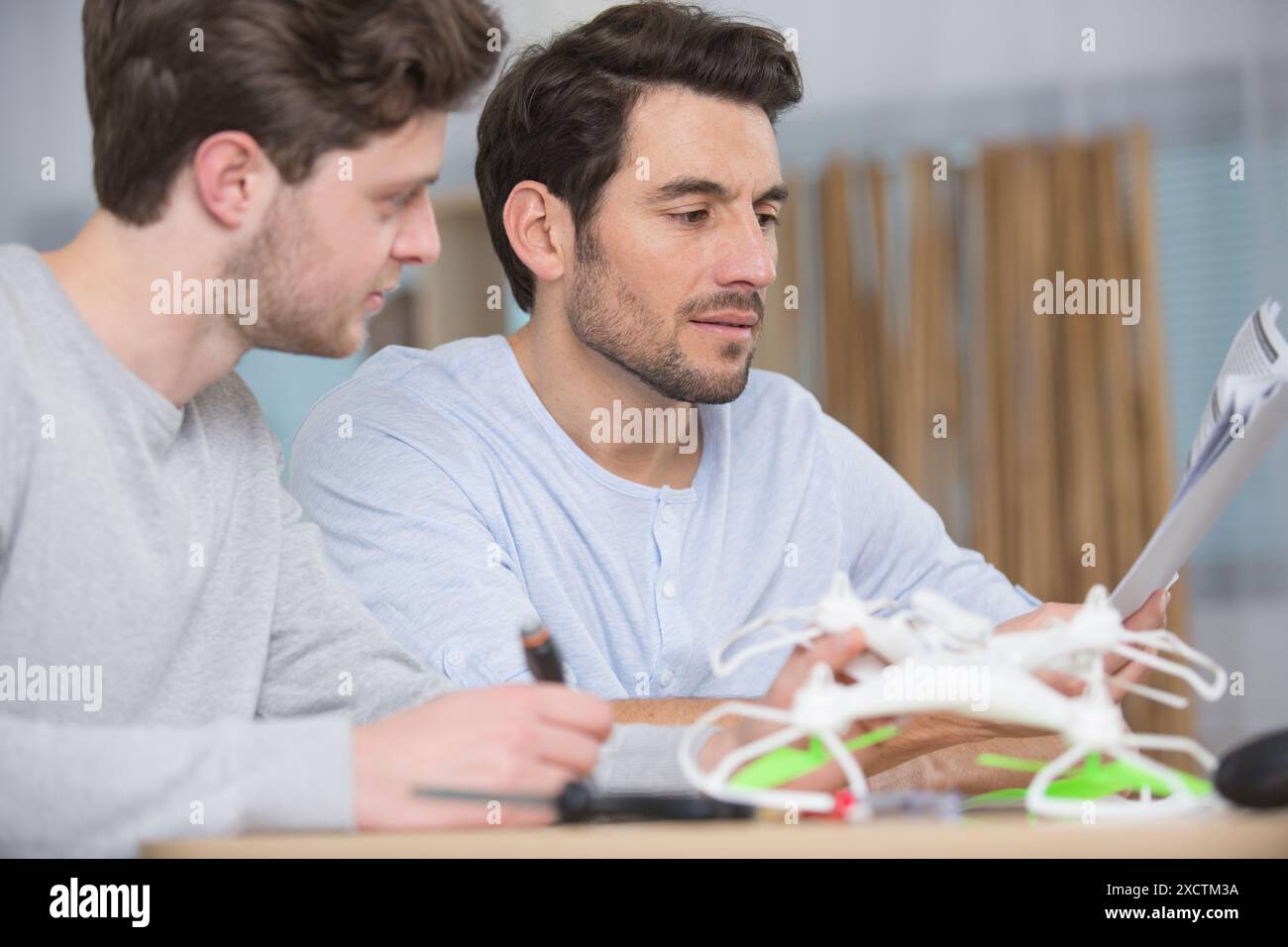 dad and son playing with toy drone Stock Photo - Alamy