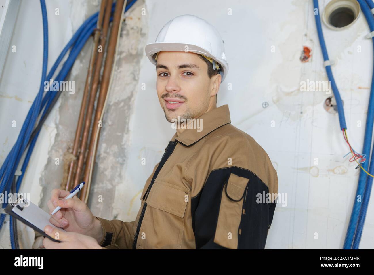 portrait of workman holding clipboard Stock Photo - Alamy