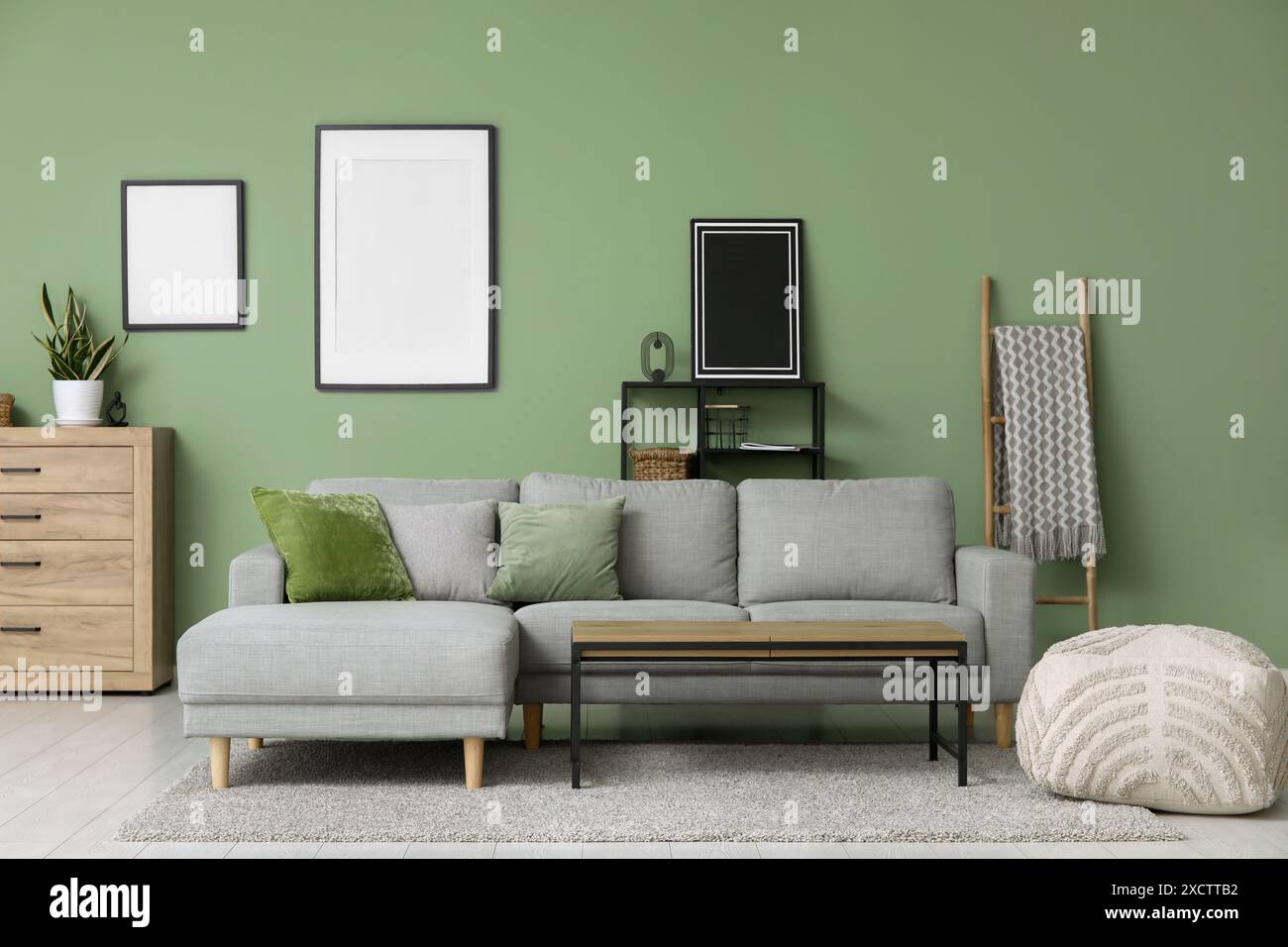 Interior of stylish living room with grey sofa, table and frames Stock ...