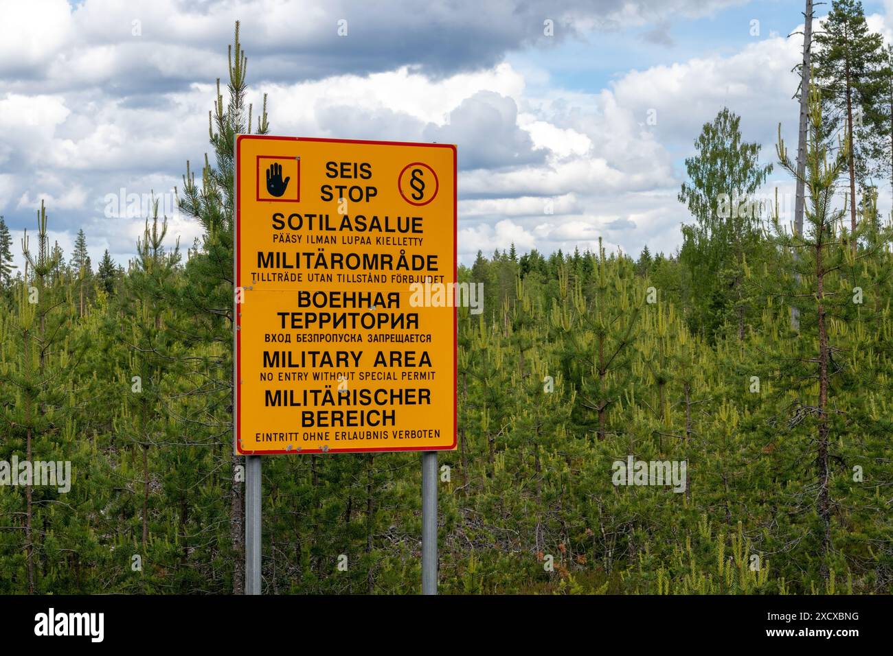 Military area keep out sign in Finnish, Swedish, Russian, English and German texts, Finland Stock Photo