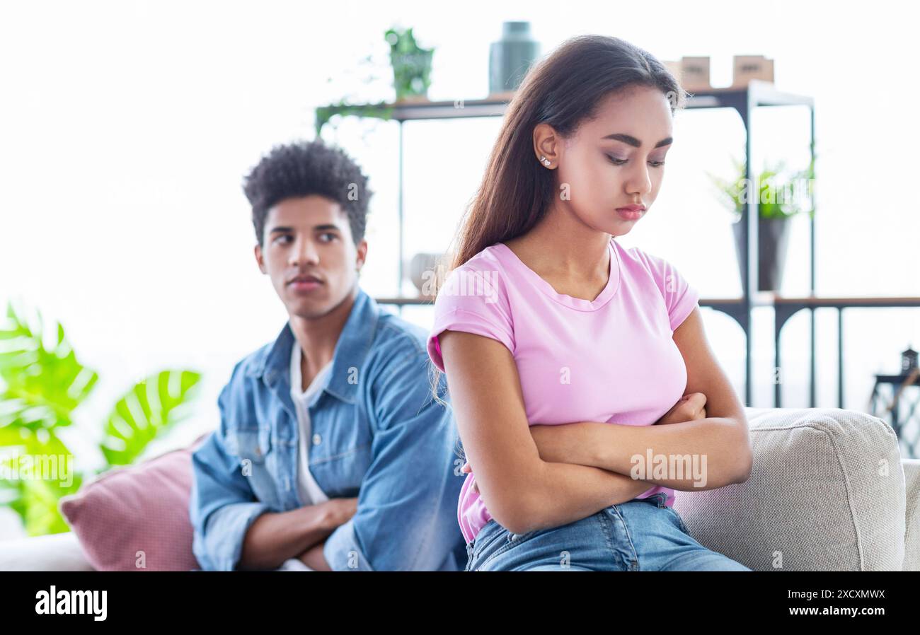 Teen Couple Sitting On Couch In Living Room After Argument Stock Photo ...