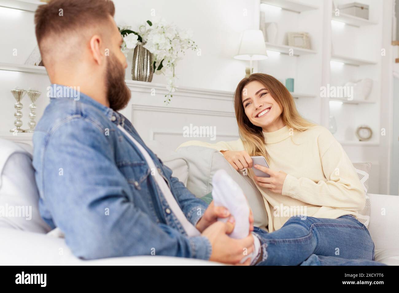 Man Sitting on Couch Next to Woman Stock Photo
