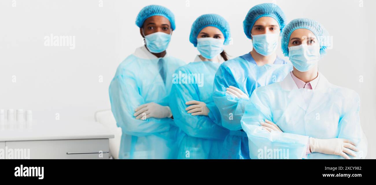 Surgeons Team Wearing Protective Uniforms, Standing In Row Stock Photo