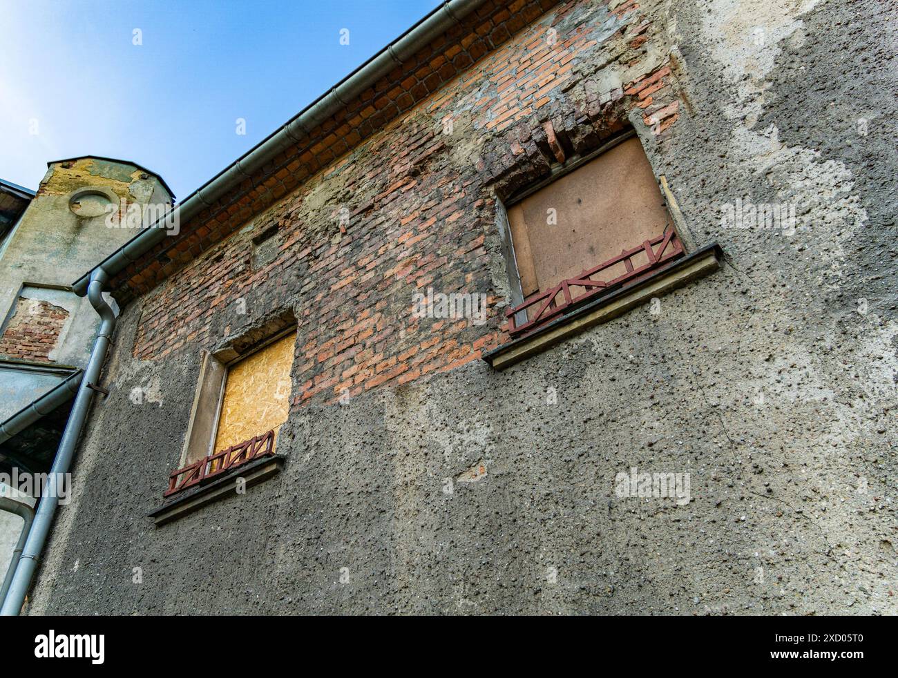 Boarded Up Windows On Old Brick Building With Gutter Stock Photo - Alamy