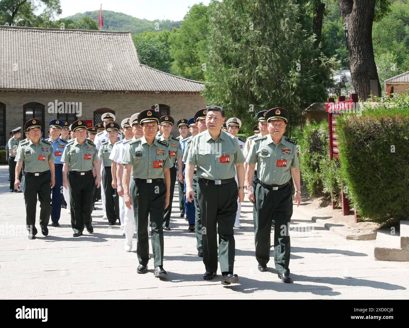 (240619) -- YAN'AN, June 19, 2024 (Xinhua) -- Chinese President Xi Jinping, also general secretary of the Communist Party of China Central Committee and chairman of the Central Military Commission (CMC), leads CMC members and heads of various departments and units to visit the revolutionary relics at Wangjiaping in Yan'an, northwest China's Shaanxi Province, June 17, 2024. The CMC Political Work Conference was held from Monday to Wednesday in Yan'an, an old revolutionary base in northwest China's Shaanxi Province. Xi attended the conference and delivered an important speech. (Xinhua/Li Gang) Stock Photo