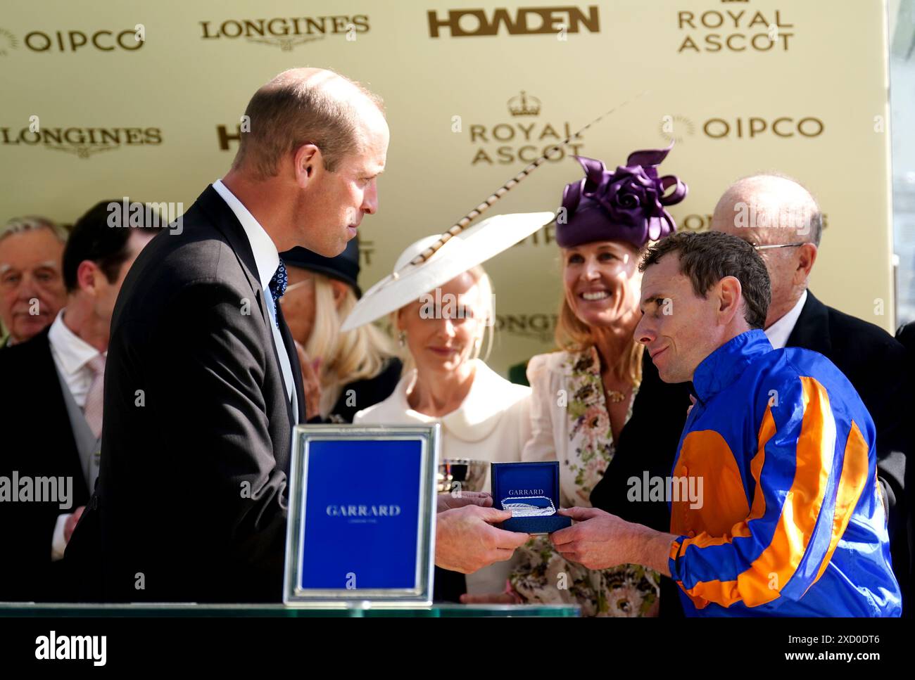 The Prince of Wales speaks to jockey Ryan Moore during the trophy ...
