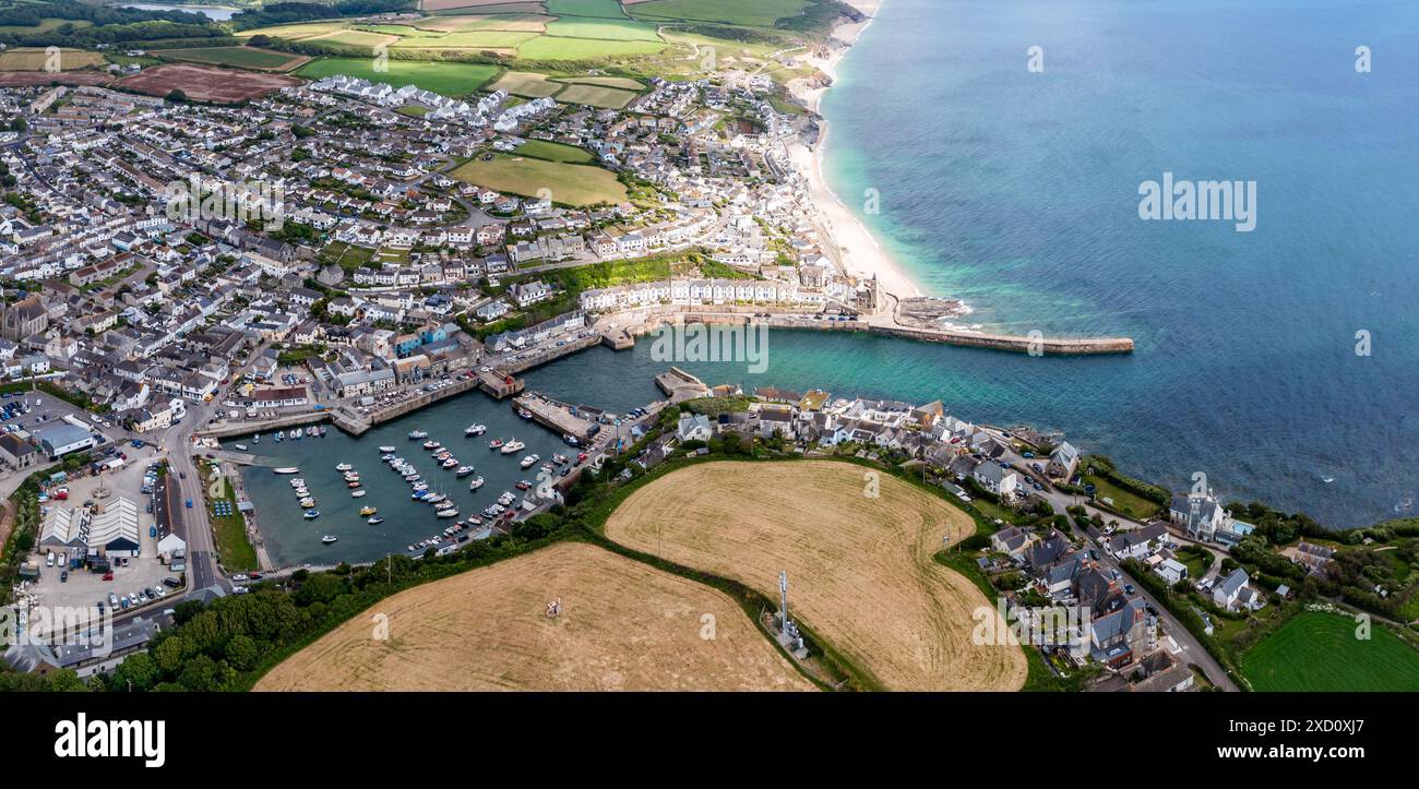 Aerial landscape of the quaint Cornish fishing town of Porthleven in Cornwall with harbour and inlet protecting a fleet of fishing boats in the popula Stock Photo