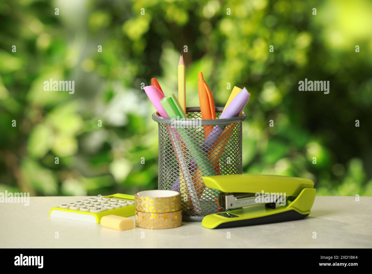 Stapler, holder and other different stationery on white table Stock Photo