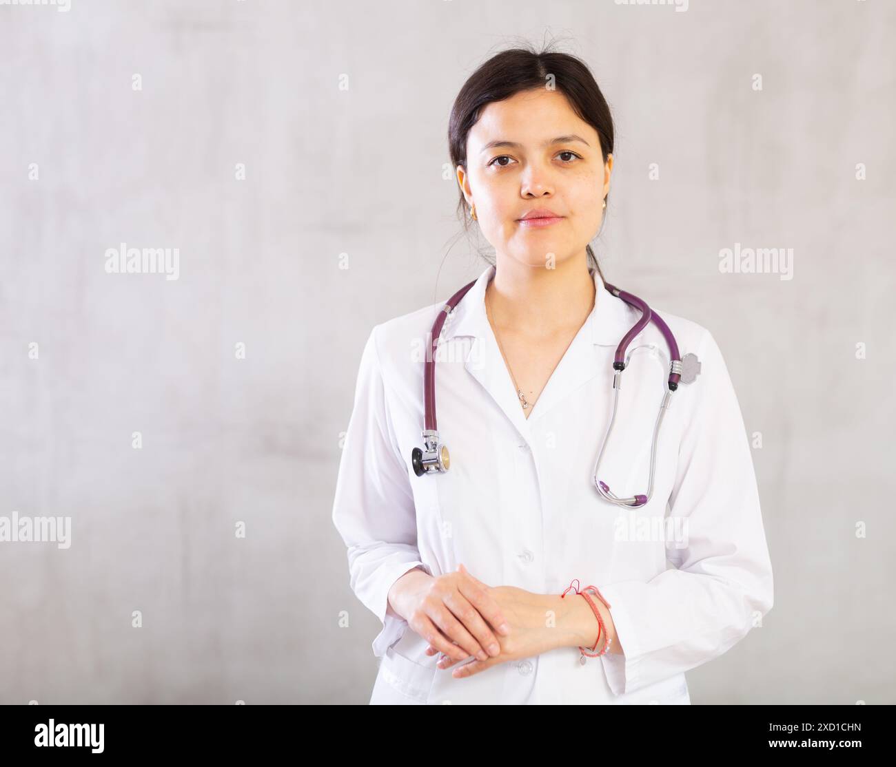 Confident positive female doctor in white uniform with stethoscope ...