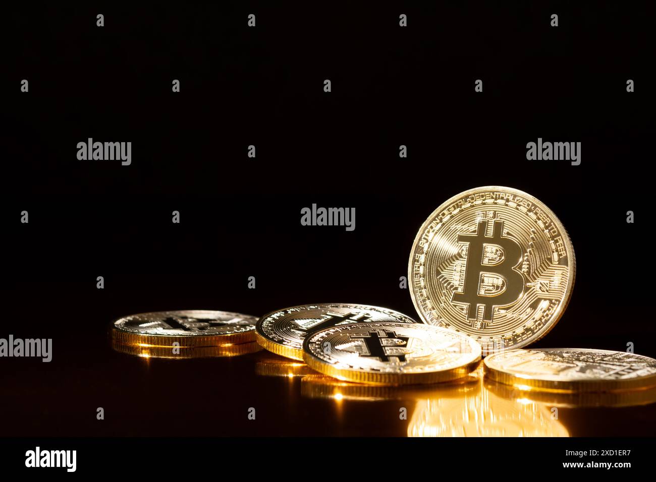 Bitcoin cryptocurrency gold coins on black background. Stock Photo