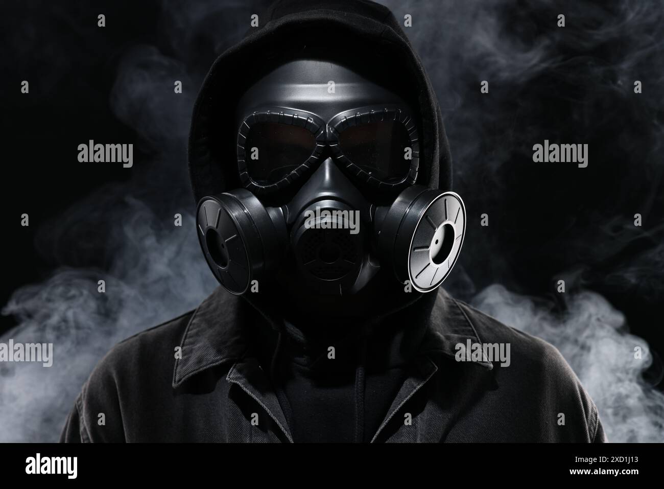Man wearing gas mask in smoke on black background Stock Photo - Alamy