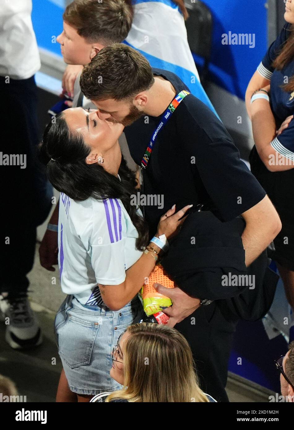 Scotland goalkeeper Angus Gunn kisses girlfriend Jade Kelly Mills, in
