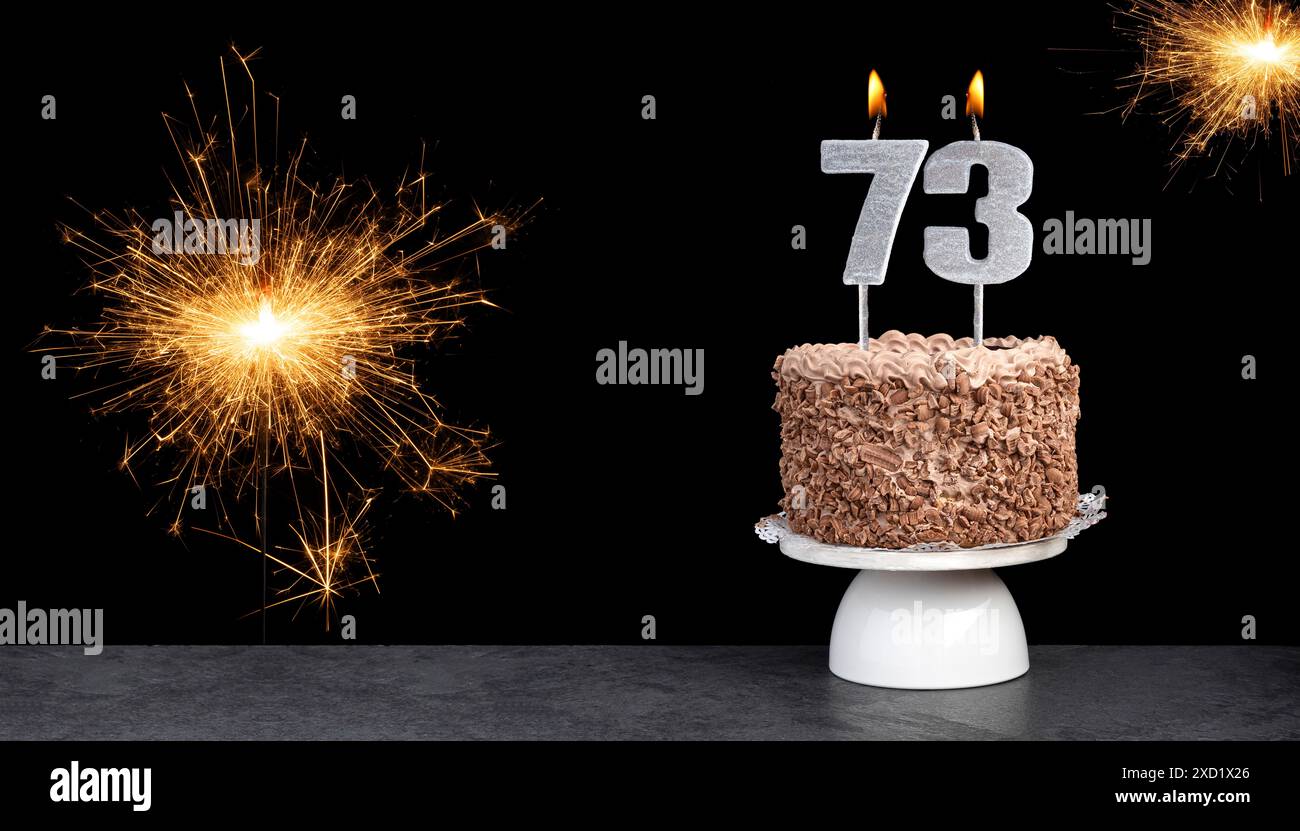 Cake with candle number 73 - Birthday card Stock Photo