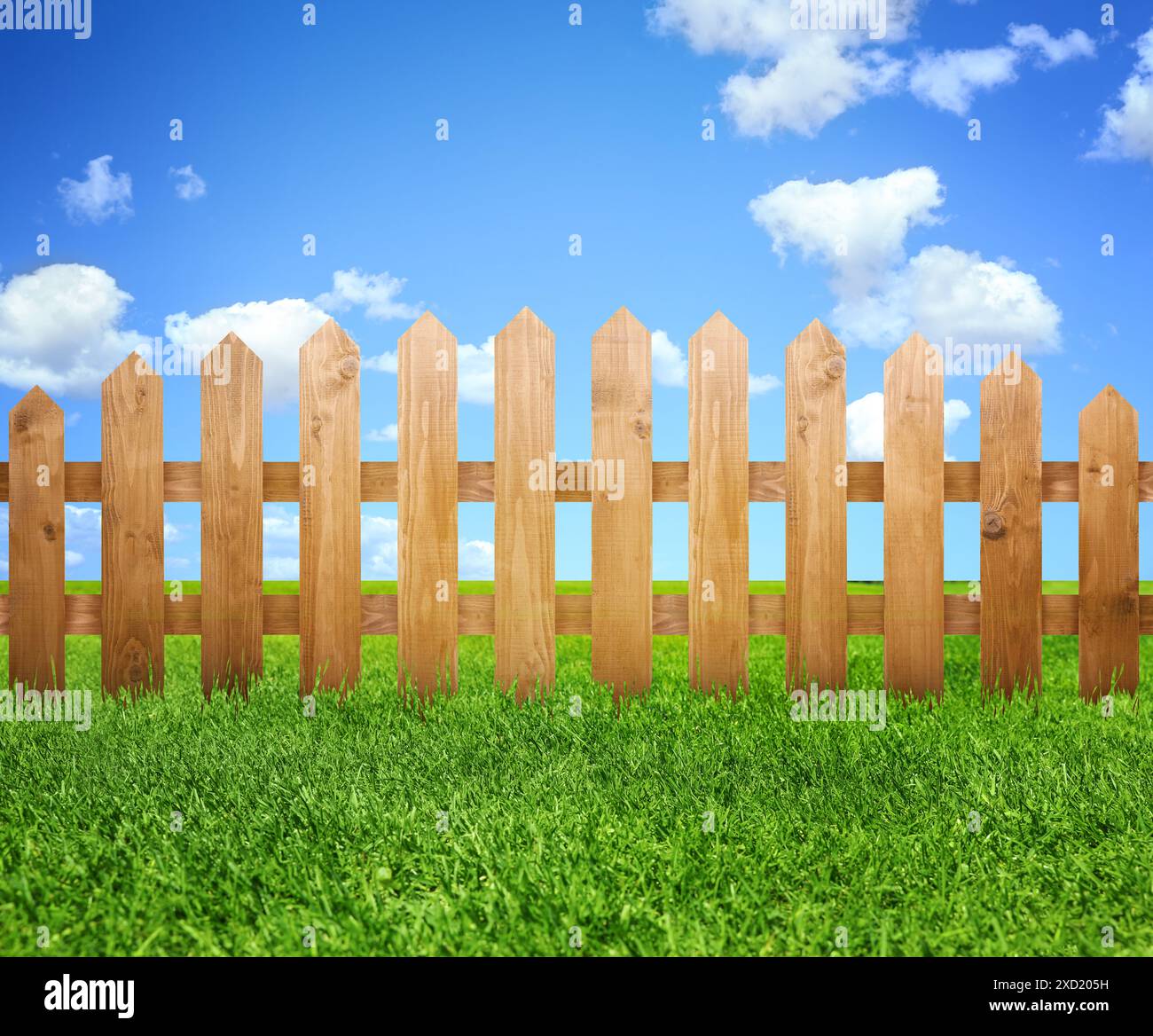 Wooden fence and green grass under blue sky with clouds outdoors Stock ...