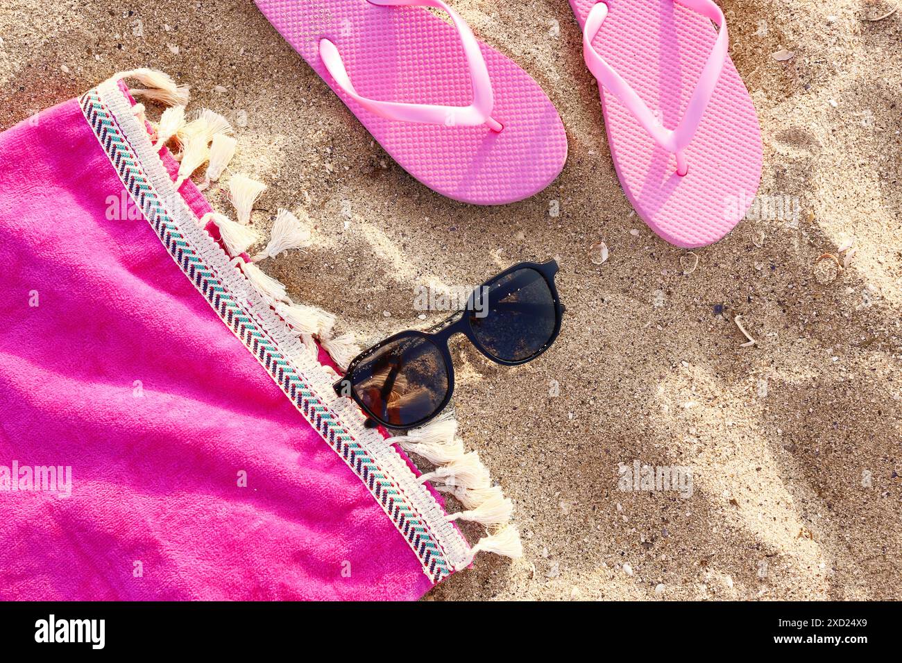 Stylish black sunglasses and flip flops on sand Stock Photo - Alamy