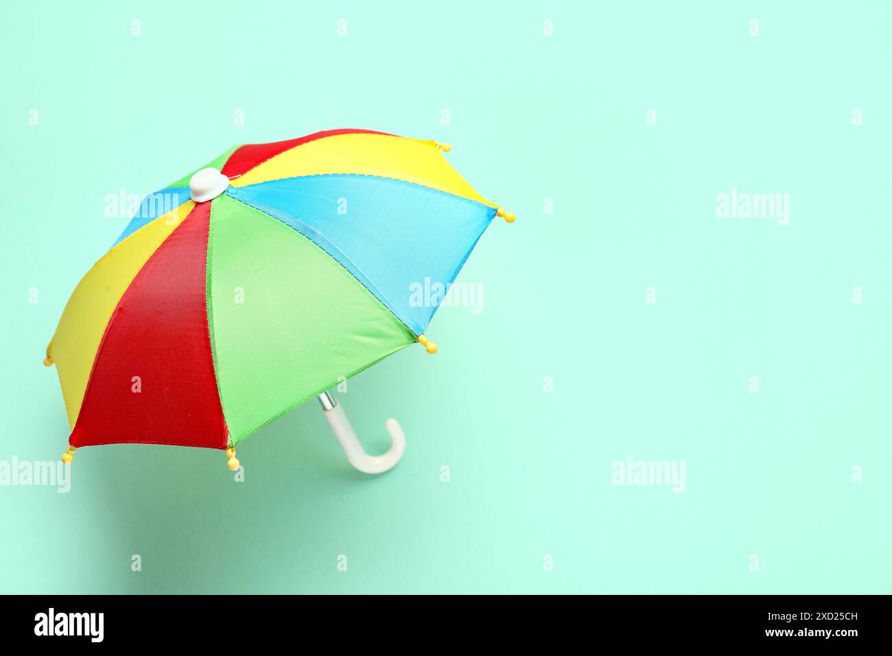 Mini colorful umbrella on green background Stock Photo