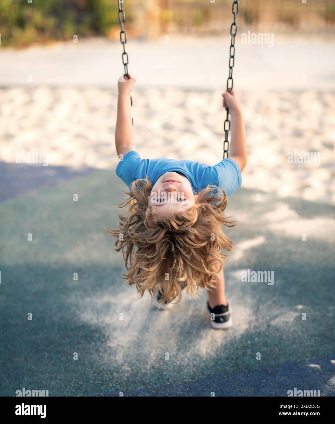 Swinging on playground. Funny kid on swing. Little boy swinging on ...