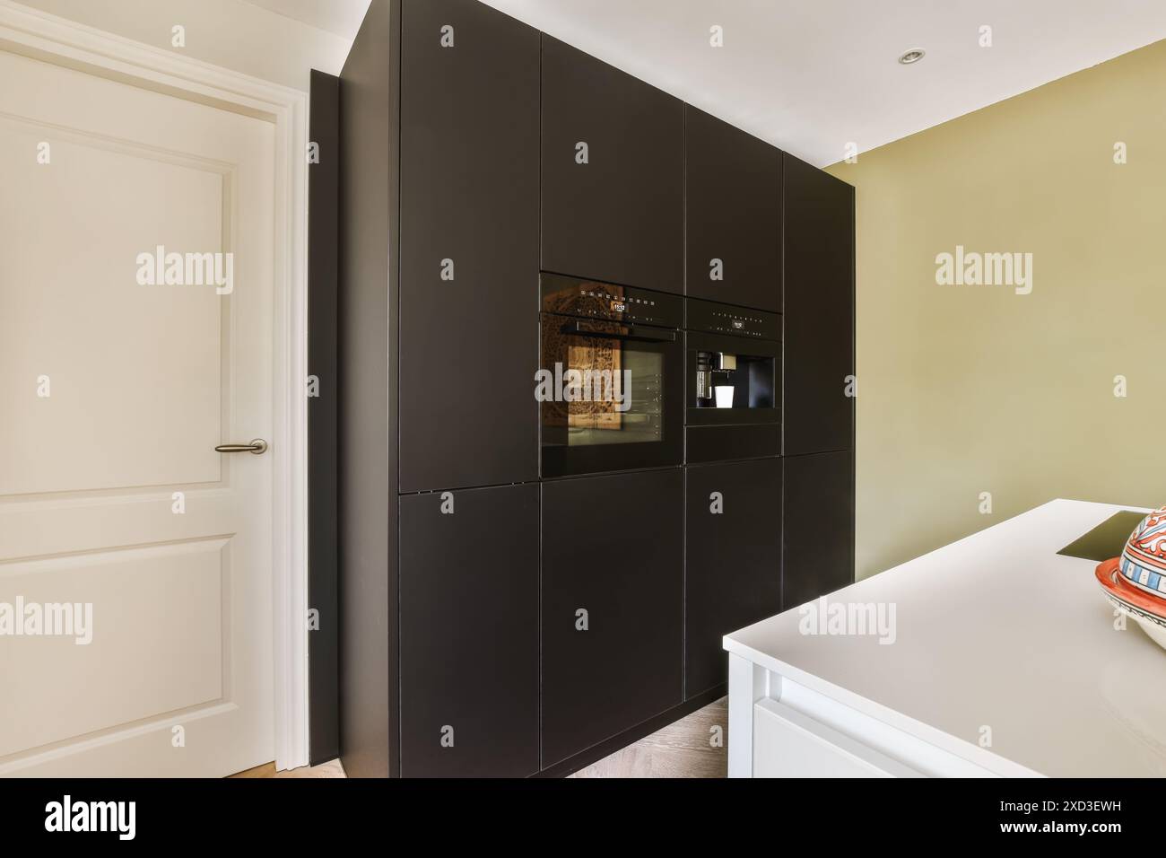 A sleek and contemporary kitchen in Slotenslaan, Netherlands featuring ...