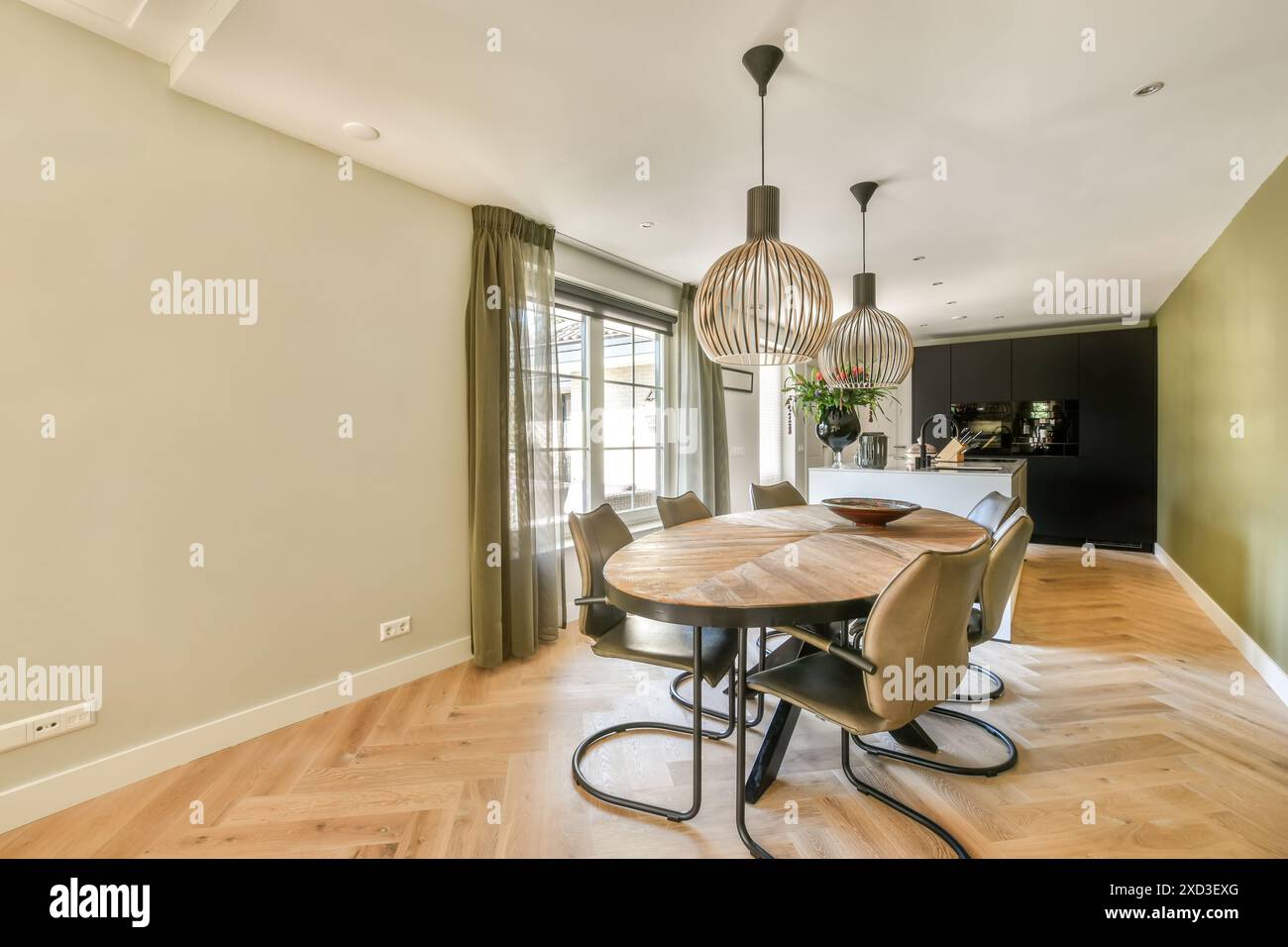 Modern dining room with stylish pendant lights and open-plan kitchen ...