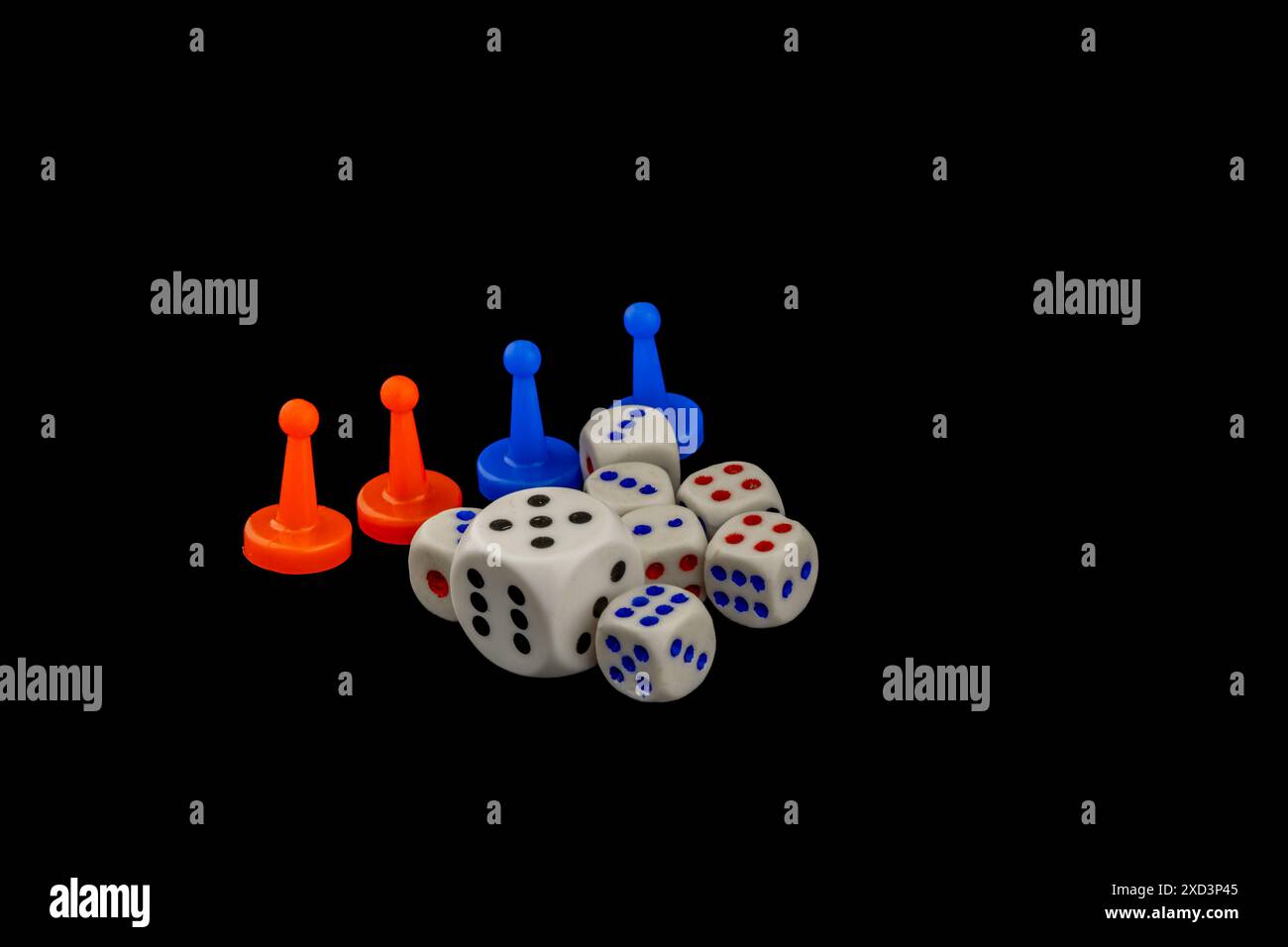 Colorful game pieces and dice on black background relaxing gambling
