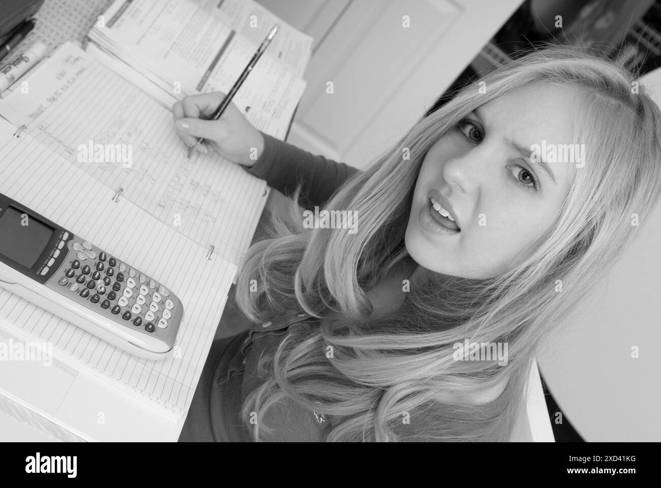 A Caucasian teenage girl ask a question about her math homework in a ...