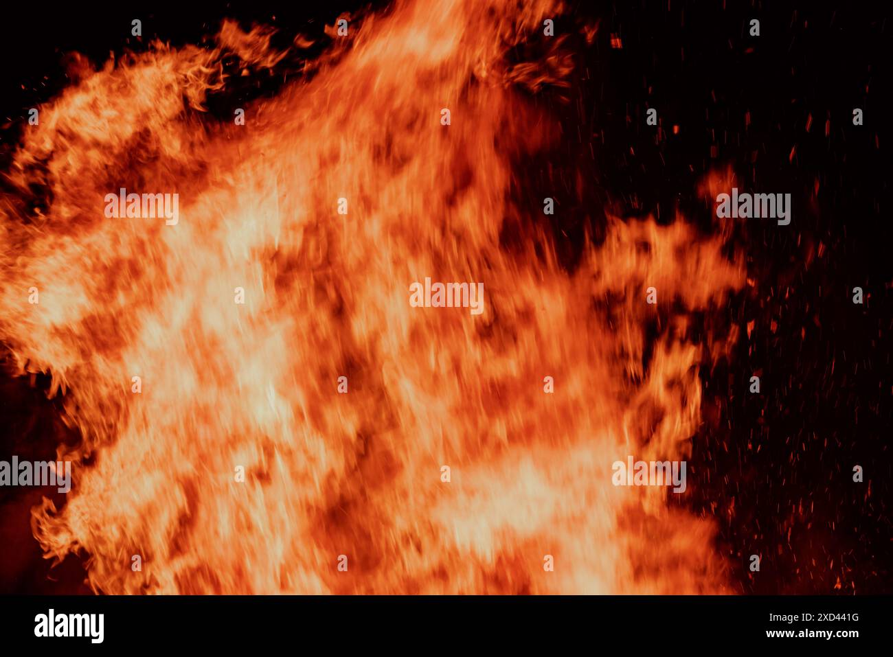 A close-up view of intense flames against a dark background Stock Photo