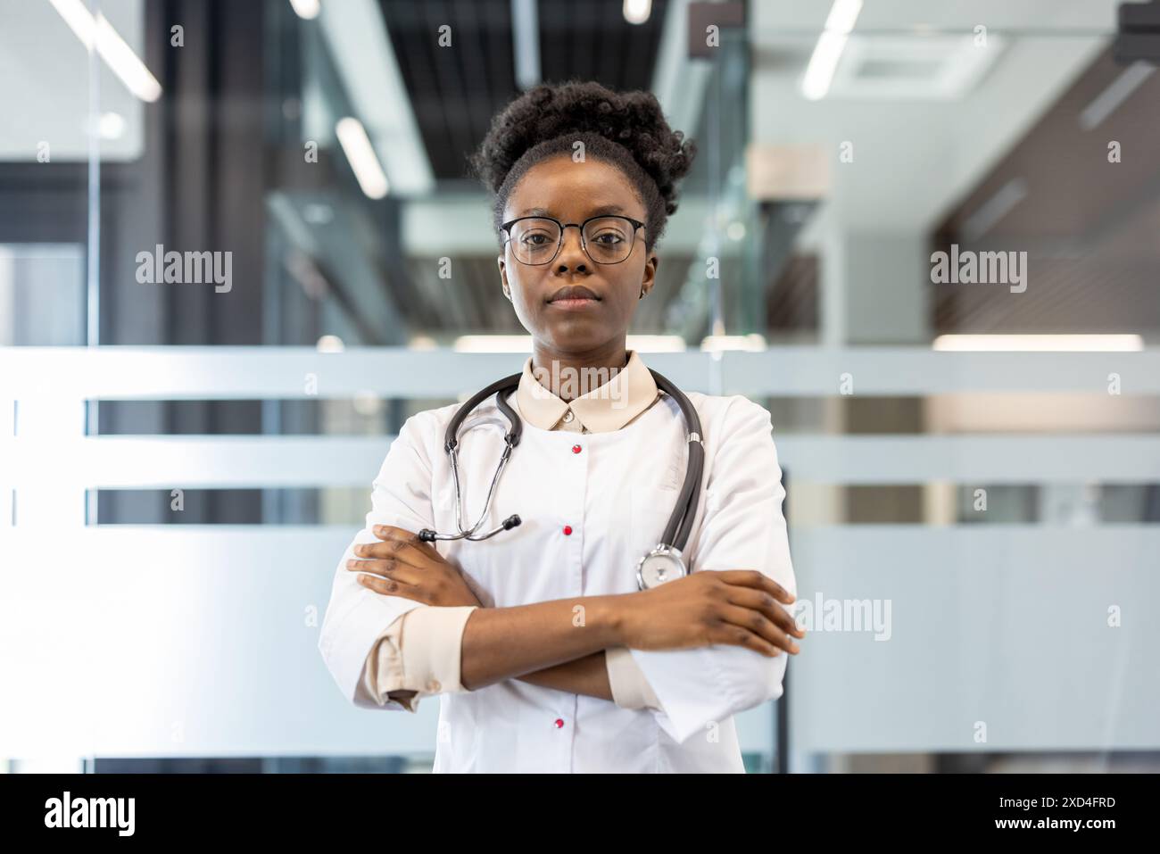 Confident female doctor with stethoscope standing in a modern medical ...