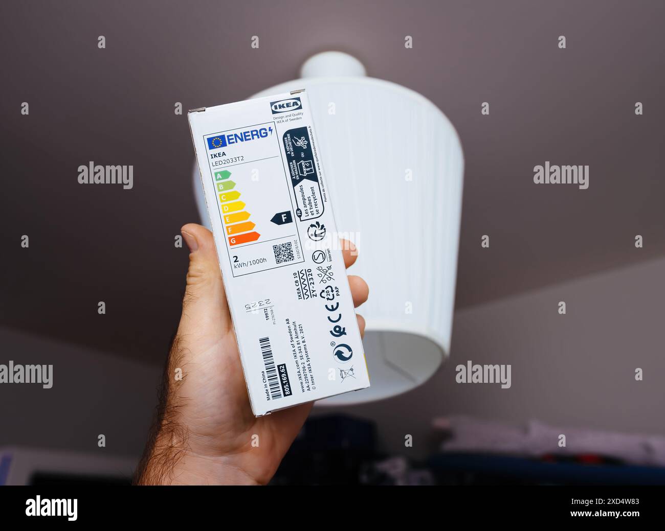Paris, France - May 24, 2024: A male hand holding a new IKEA bulb with ...