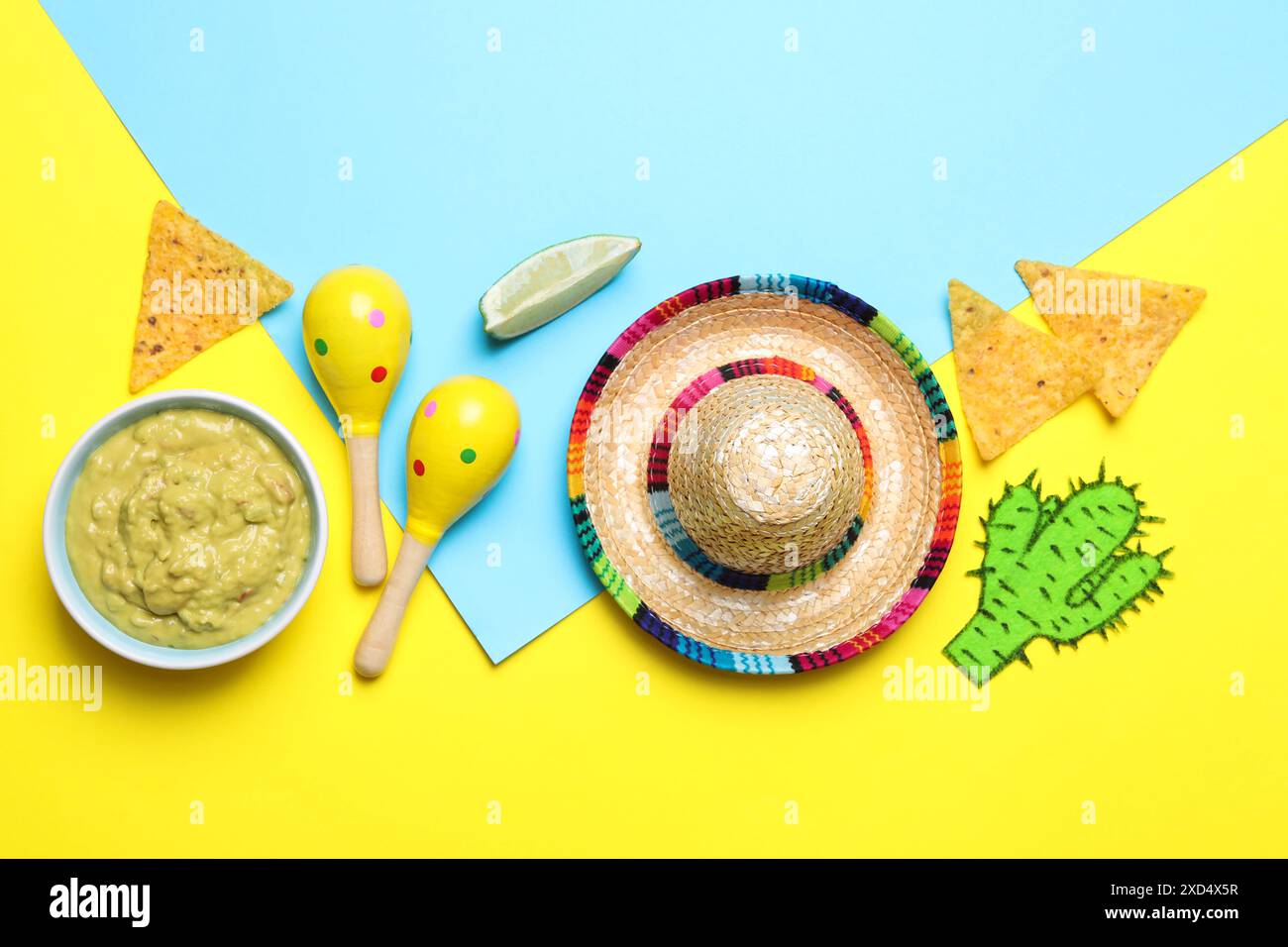 Mexican sombrero hat, nachos chips, guacamole, maracas and paper cactus