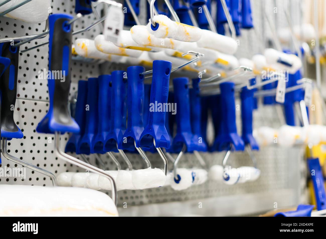 A store display of paint brushes and rollers. The display is organized ...