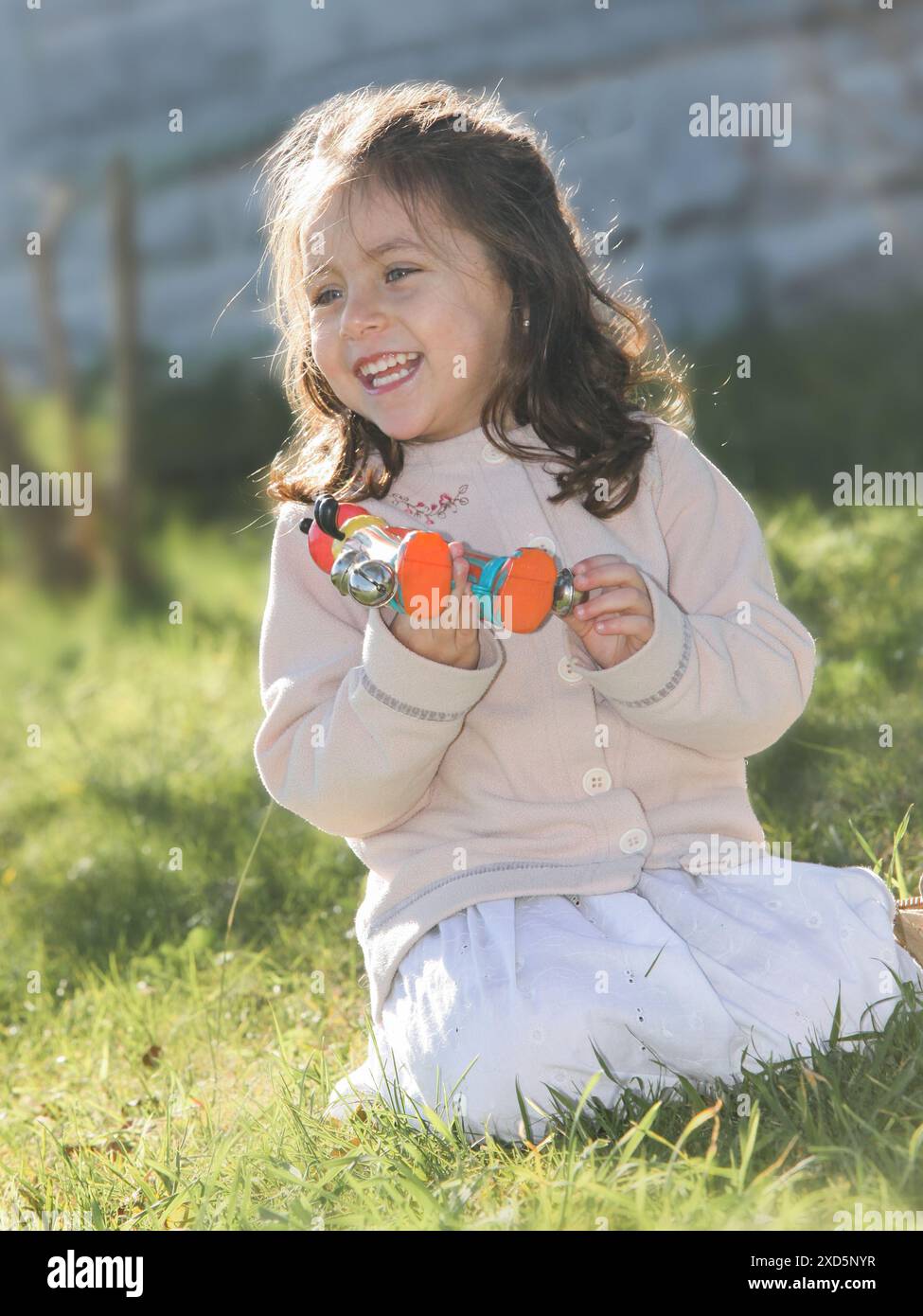 cheerful little girl with an a vintage toy and teddy bear Stock Photo
